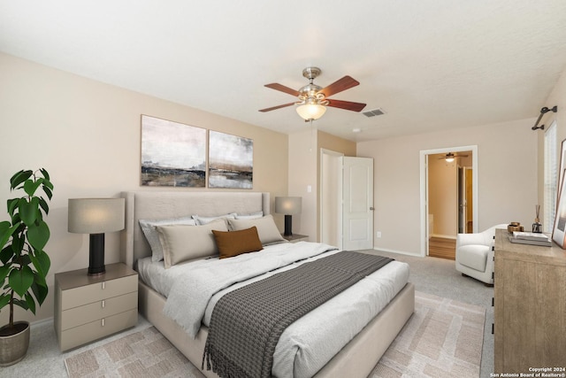 bedroom with baseboards, visible vents, light carpet, and ceiling fan