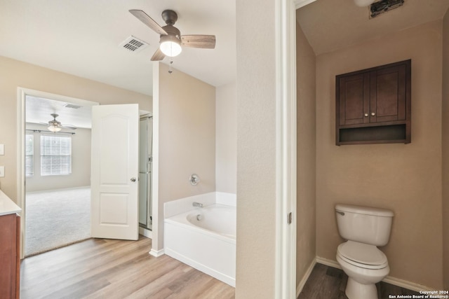 bathroom with visible vents, a garden tub, a stall shower, wood finished floors, and a ceiling fan
