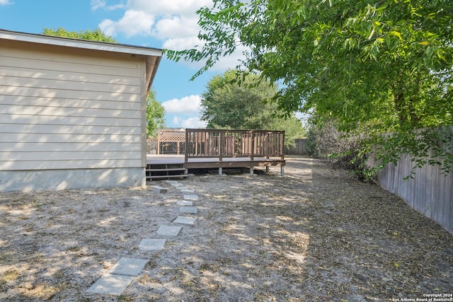 view of yard with a deck and a fenced backyard