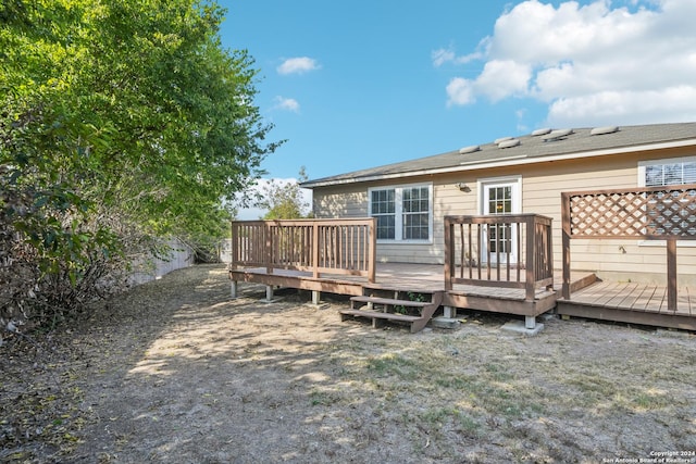 back of property with a wooden deck