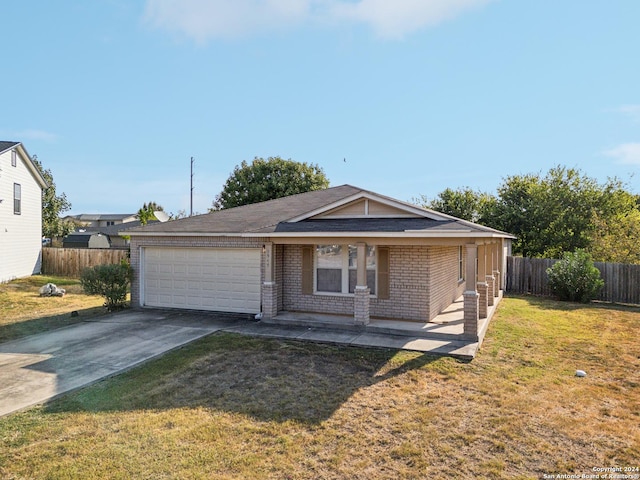 ranch-style home with a front yard, a garage, brick siding, concrete driveway, and fence