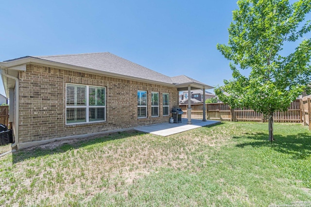 2004 Pillard Smt, San Antonio, TX 78245 - rear view of property with brick siding, a patio area, and roof with shingles