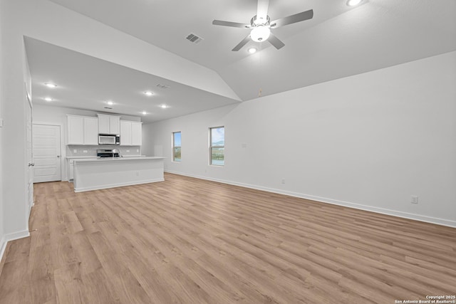unfurnished living room featuring recessed lighting, light wood-style floors, ceiling fan, visible vents, and lofted ceiling