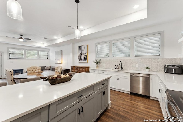 kitchen with light countertops, stainless steel appliances, visible vents, and a sink