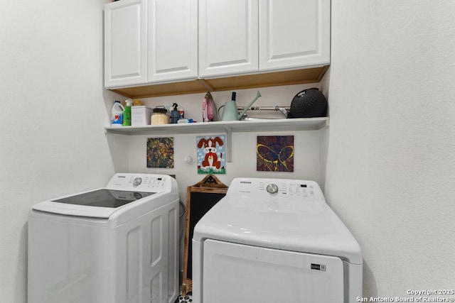 laundry area with washer and dryer and cabinet space