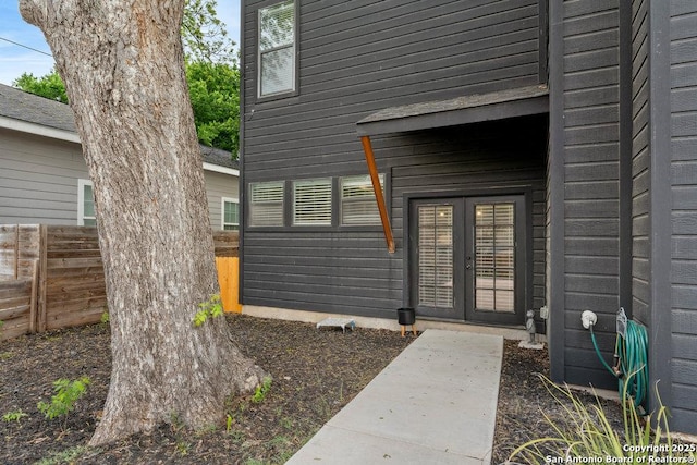 entrance to property featuring fence and french doors