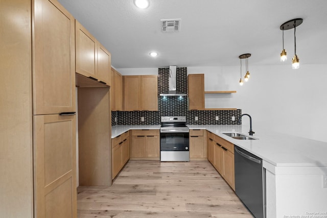kitchen featuring wall chimney exhaust hood, a peninsula, visible vents, light brown cabinets, and appliances with stainless steel finishes