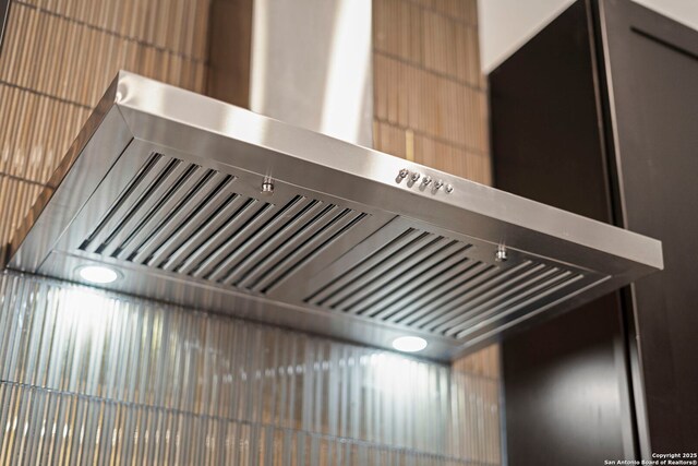 interior details with wall chimney range hood