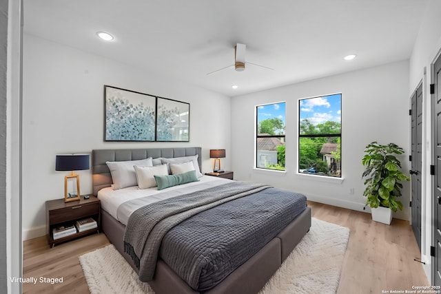 bedroom with light wood finished floors, baseboards, and recessed lighting