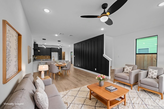 living area featuring light wood finished floors, visible vents, recessed lighting, and ceiling fan