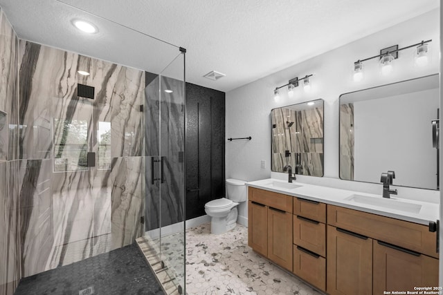 full bathroom with a marble finish shower, a sink, a textured ceiling, and toilet