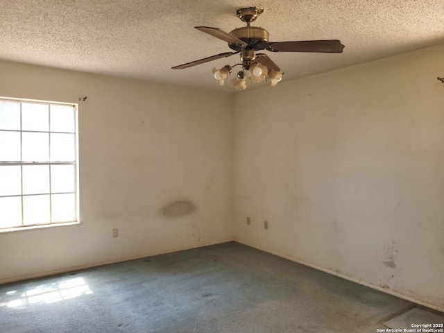 carpeted empty room with a textured ceiling and ceiling fan
