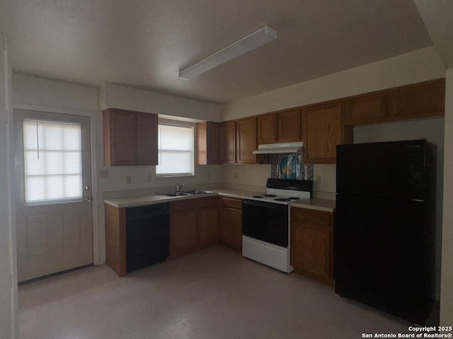 823 Dallas, Pleasanton, TX 78064 - kitchen with a sink, black appliances, brown cabinets, light countertops, and under cabinet range hood