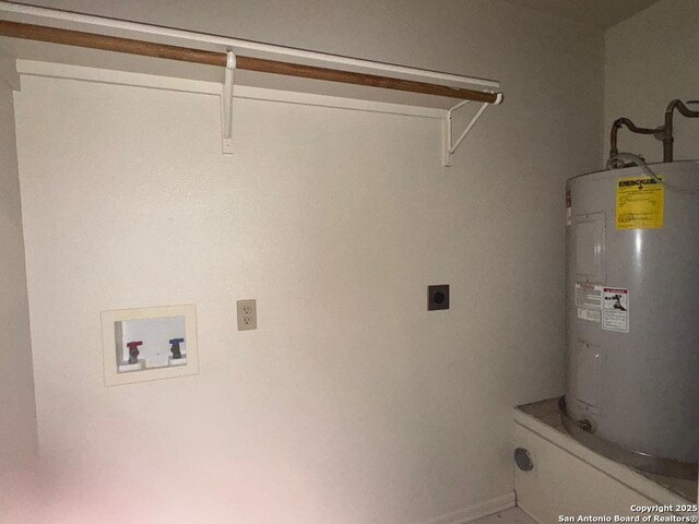 823 Dallas, Pleasanton, TX 78064 - clothes washing area featuring hookup for an electric dryer, baseboards, washer hookup, water heater, and laundry area