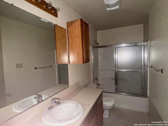 823 Dallas, Pleasanton, TX 78064 - bathroom featuring tile patterned flooring, enclosed tub / shower combo, toilet, and vanity