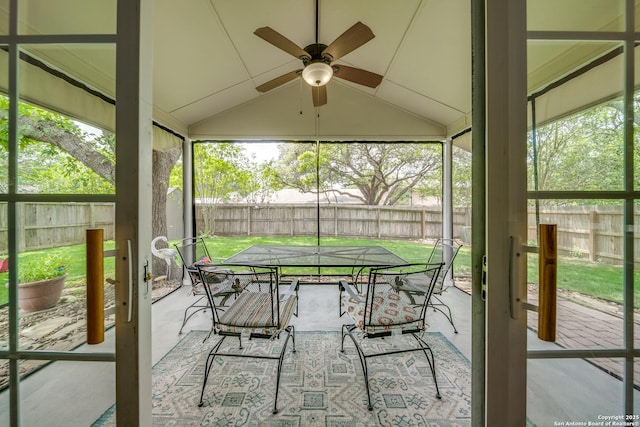 sunroom / solarium with outdoor dining space and ceiling fan