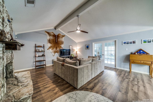 living area with wood finished floors, visible vents, and baseboards