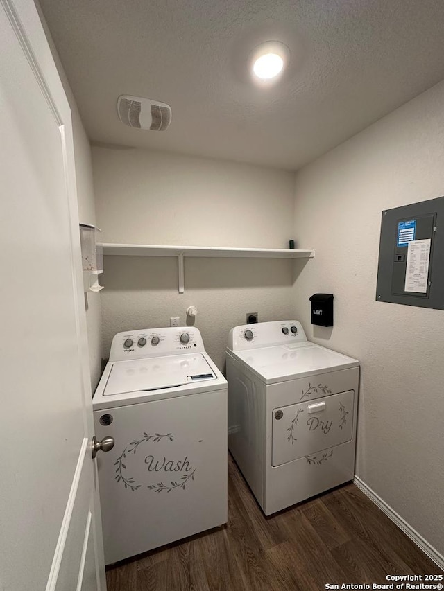 washroom featuring laundry area, visible vents, electric panel, washer and dryer, and dark wood-style flooring