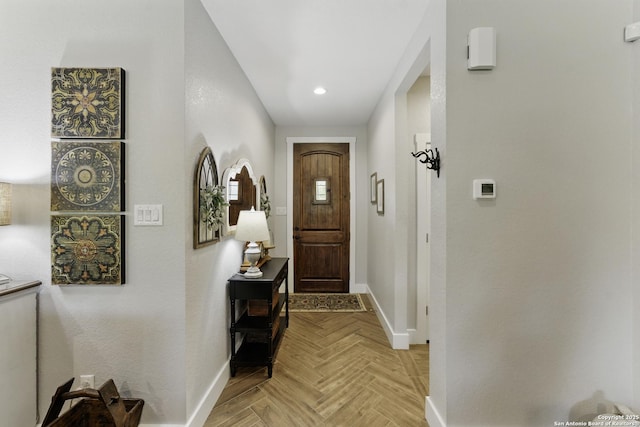 doorway to outside featuring baseboards and recessed lighting