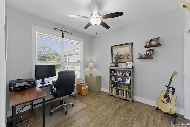 office area with baseboards, wood finished floors, and ceiling fan