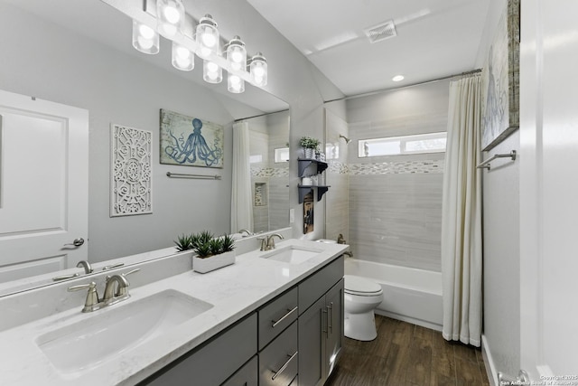 bathroom featuring double vanity, wood finished floors, shower / tub combo with curtain, and a sink