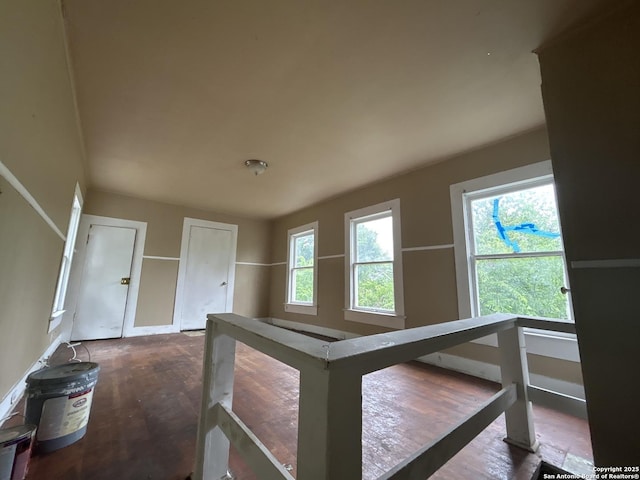 hallway featuring baseboards and an upstairs landing