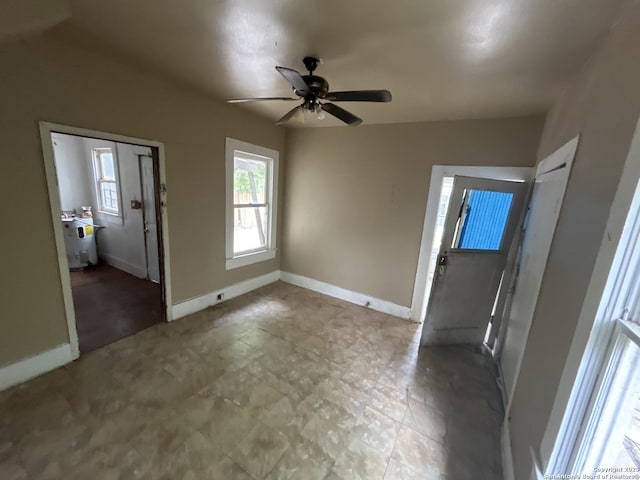 interior space with ceiling fan and baseboards