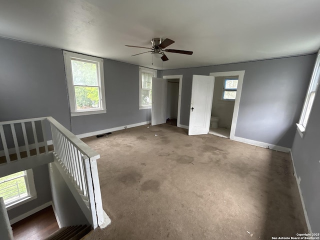 unfurnished bedroom with baseboards and a ceiling fan