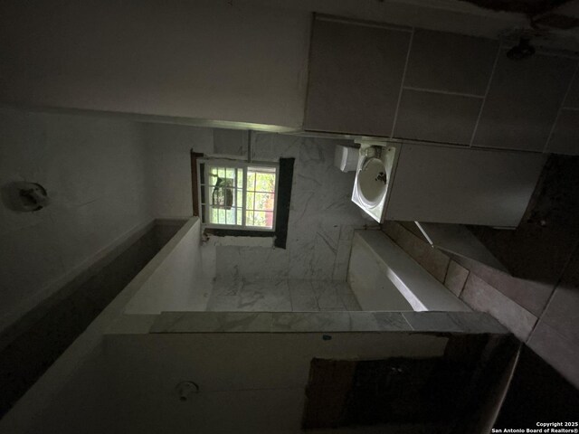 bathroom featuring marble finish floor