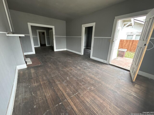 329 Hot Wls, San Antonio, TX 78223 - unfurnished living room featuring baseboards and wood finished floors