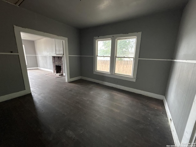 329 Hot Wls, San Antonio, TX 78223 - spare room with baseboards, wood finished floors, and a fireplace