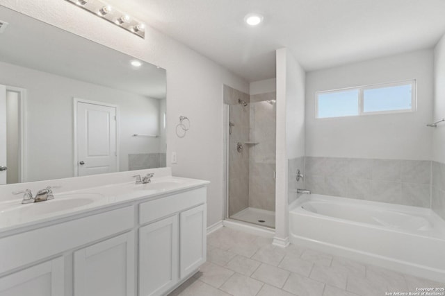 full bath featuring tile patterned flooring, a bath, a sink, and a stall shower