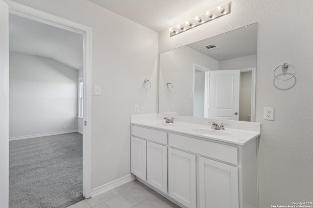 full bath with tile patterned flooring, double vanity, visible vents, a sink, and baseboards