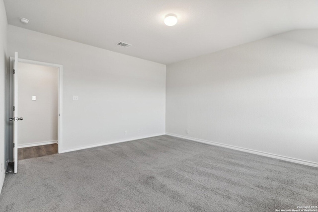 carpeted empty room featuring visible vents and baseboards