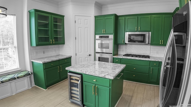 kitchen with wine cooler, green cabinets, stainless steel appliances, and backsplash