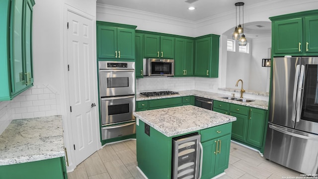 kitchen featuring crown molding, appliances with stainless steel finishes, a sink, wine cooler, and a warming drawer