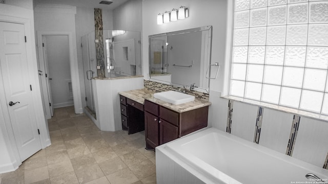bathroom featuring vanity, a stall shower, and a bathtub