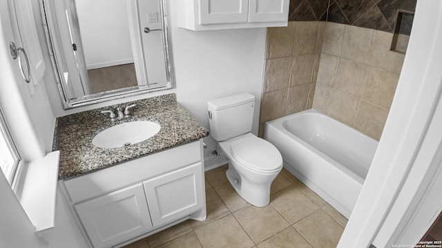 bathroom with toilet, tile patterned floors, and vanity