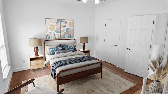 bedroom with crown molding, baseboards, and wood finished floors