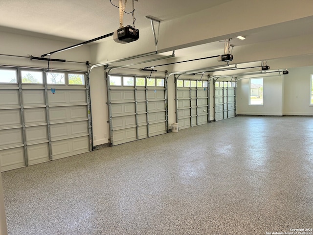 garage with baseboards and a garage door opener