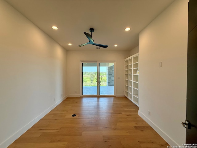 empty room with recessed lighting, light wood-style floors, and baseboards