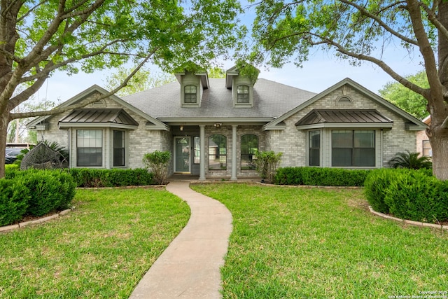 109 Weeping Willow, Uvalde, TX 78801 - view of front of home with brick siding, roof with shingles, and a front yard
