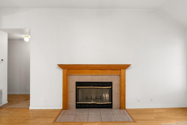 109 Weeping Willow, Uvalde, TX 78801 - room details with wood finished floors, a tile fireplace, and baseboards
