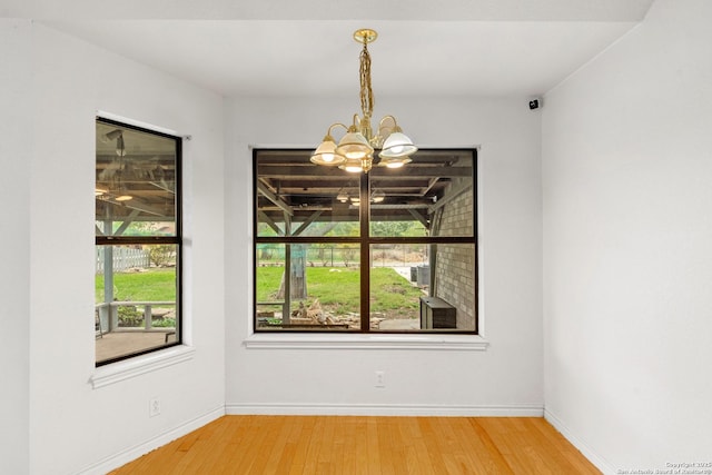 109 Weeping Willow, Uvalde, TX 78801 - spare room with baseboards, wood finished floors, and a notable chandelier