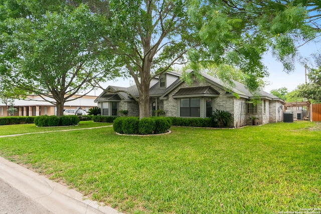 109 Weeping Willow, Uvalde, TX 78801 - ranch-style home with fence, brick siding, a front yard, and cooling unit