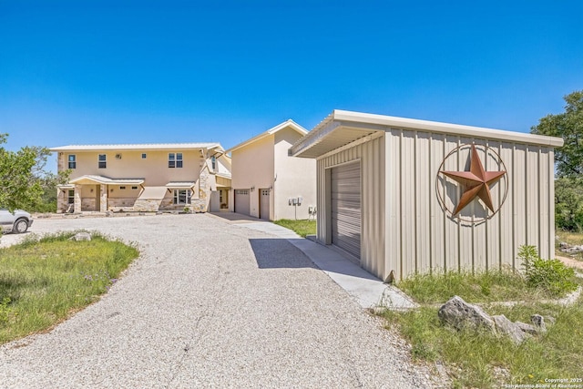 view of front of house featuring stucco siding and driveway