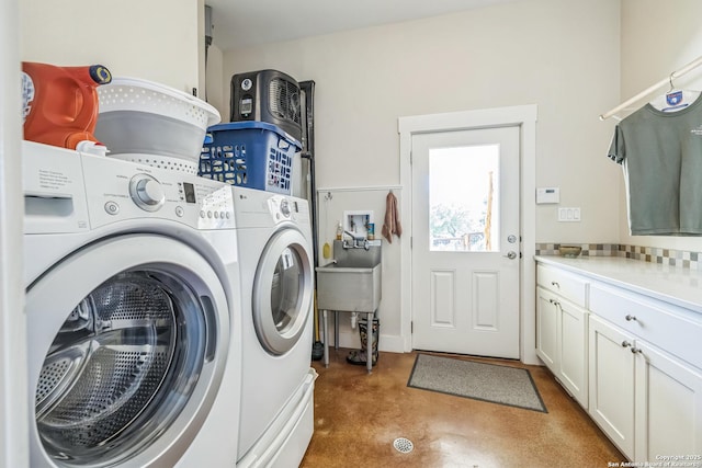washroom with cabinet space and separate washer and dryer