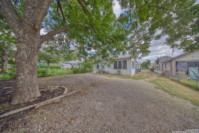 view of yard featuring driveway and fence