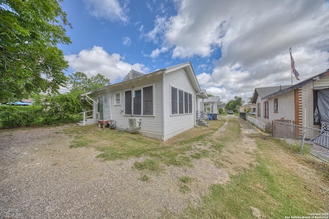 view of property exterior with fence and a pergola