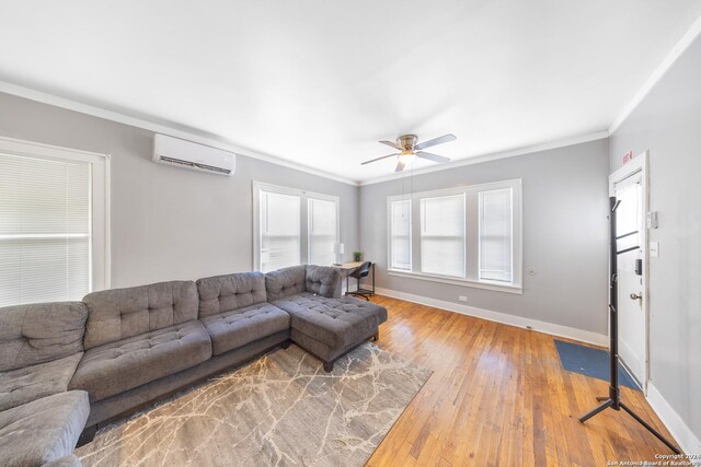 living room featuring ceiling fan, baseboards, ornamental molding, and a wall mounted AC